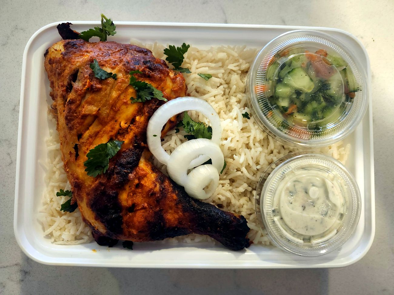 Tandoori chicken with basmati rice, cucumber salad and raita